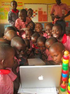 groups of students looking at computer