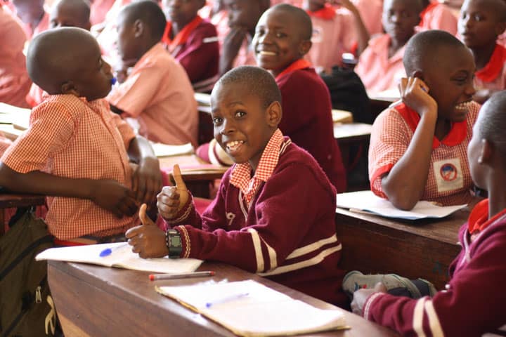 boy in class giving thumbs up