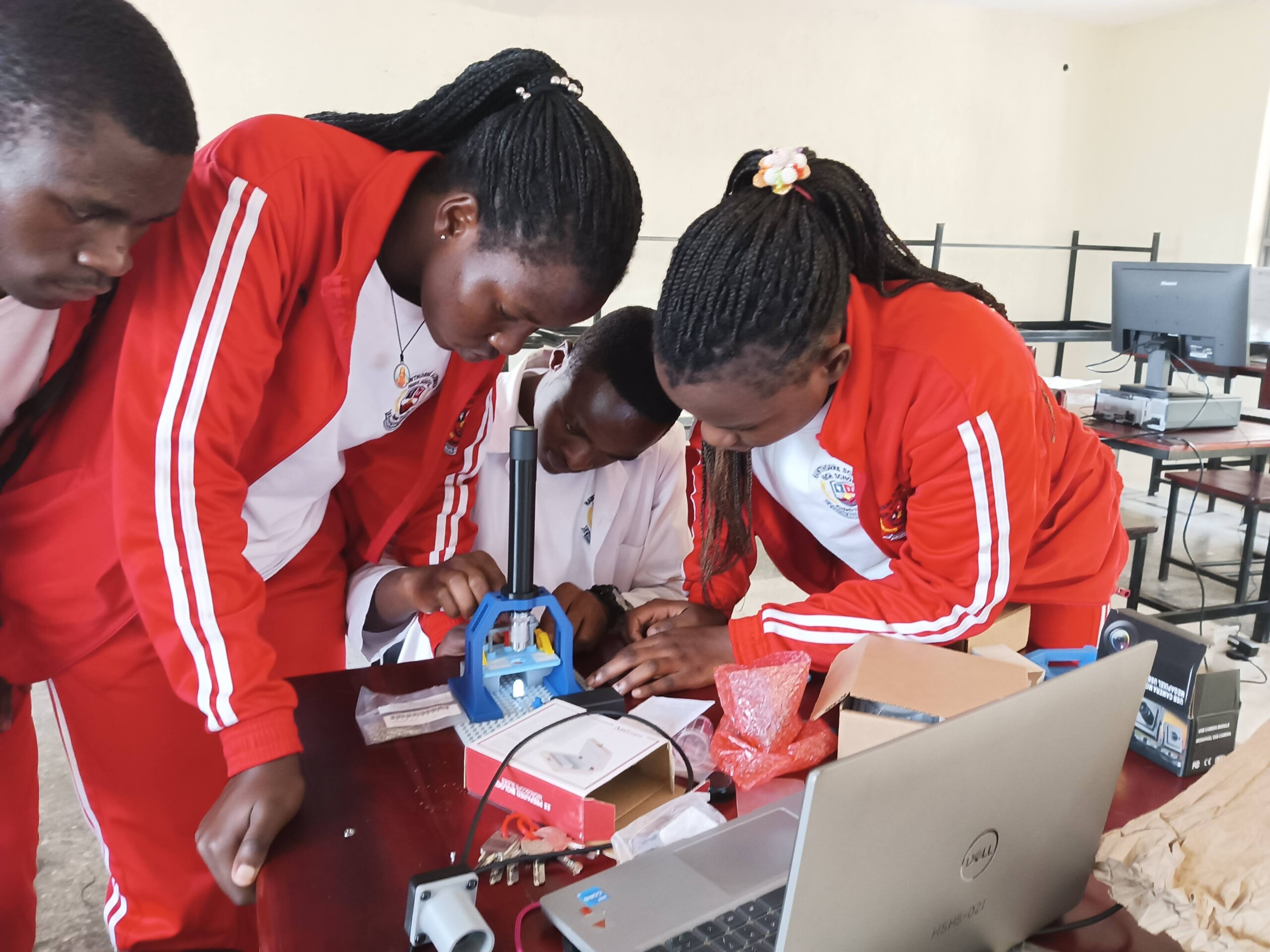 Students at Hawthorne-Scribner High School assemble a 3D-printed Microscope