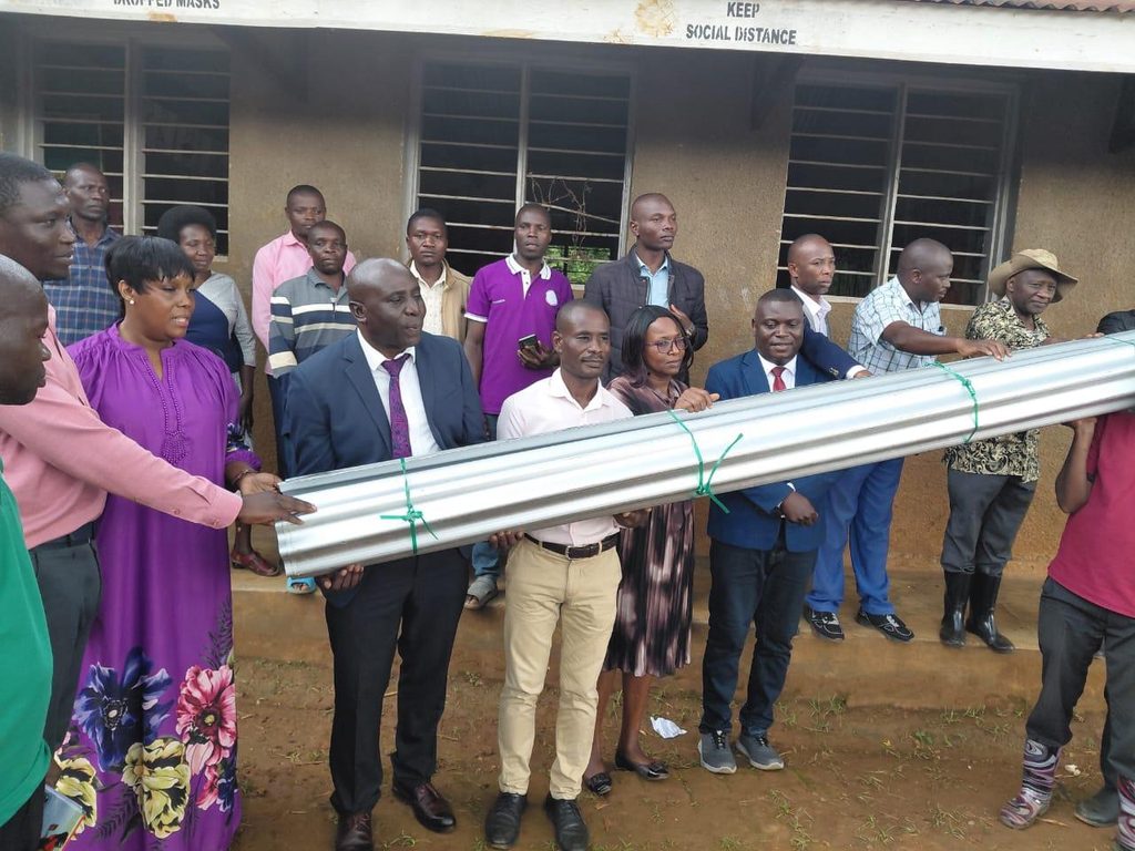 Handover of roofing iron sheets for Kitchen construction in schools